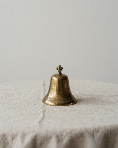 Single brass bell still life - pairing with a member quote about verified community trust